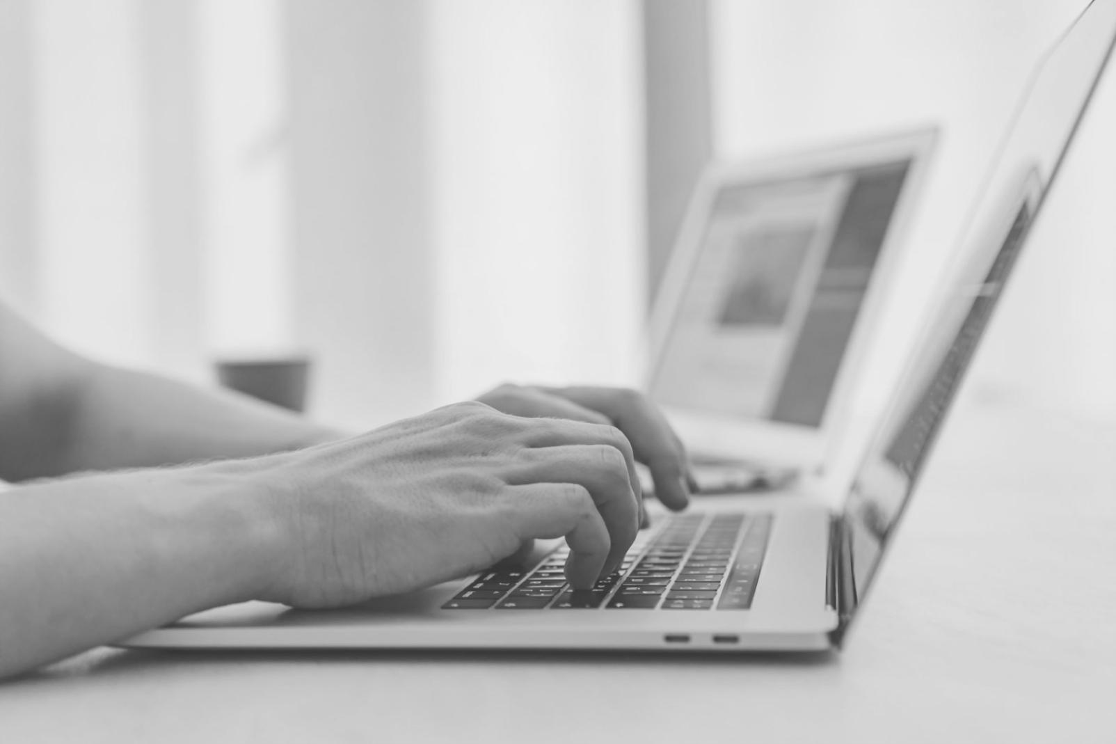 Modern workspace showing collaborative design process with multiple screens and design materials