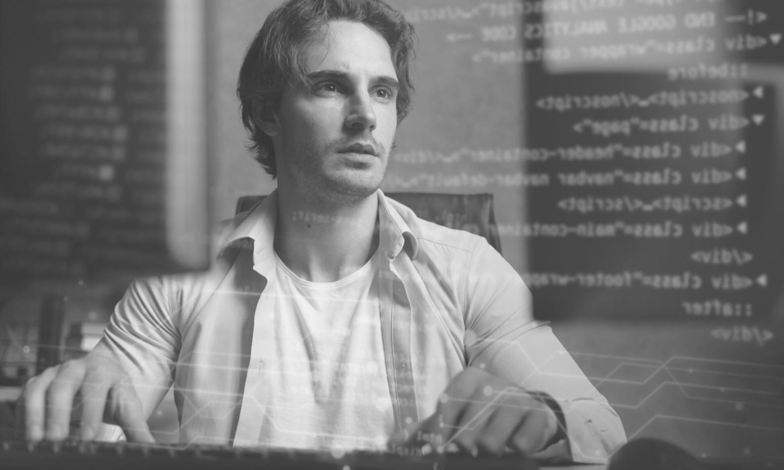 Collaborative design session showing wireframes and prototypes on large monitors